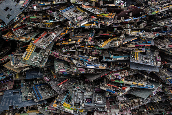 GUIYU TOWN, GUIYU, GUANGDONG, CHINA - 2015/07/18: This photo shows electronic waste in a recycling factory inside the well know town of Guiyu as business grow up each year where the worlds electronic chips waste end up for recycling. The small Town of Guiyu is also knows as the E Cemetery in the World, since a couple of years, people starting to suffer from various disease, mostly due to the air pollution caused by the factories and also the method of dismantling the electronic waste, as most of the workers burn the electronic component to collect the precious metal and dont use any protective material. (Photo by Guillaume Payen/LightRocket via Getty Images)